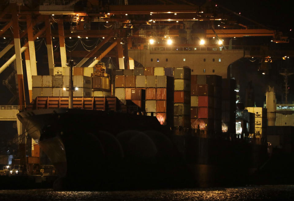 Containers are moved inside the cargo ship M/V Bavaria as it is docked at Subic port in Zambales province, northwestern Philippines on Thursday, May 30, 2019. A Philippine official says a cargo ship has arrived in a northern port to pick up and return 69 containers of Canadian garbage which the government in Manila says was shipped illegally to the Philippines years ago. (AP Photo/Aaron Favila)