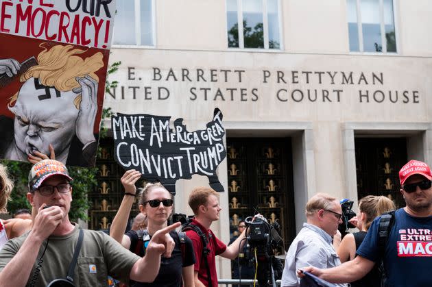 Protesters shout pro-Trump slogans in front of the E. Barrett Prettyman U.S. Courthouse.