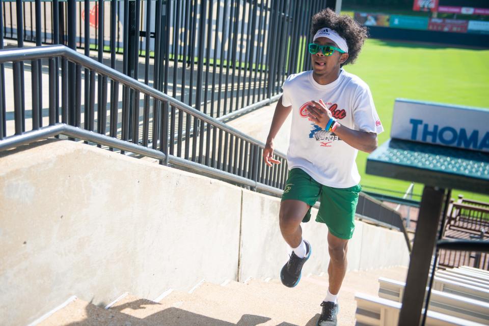 Jackson Central-Merry football player Keyon Davis hustles up the stairs to become the first person to complete the 2nd Annual Patriot Day Memorial Stair Climb at the Ballpark at Jackson on Saturday, Sept. 9, 2023.