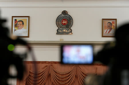 FILE PHOTO - Profile images of Sri Lanka's newly appointed Prime Minister Mahinda Rajapaksa (R) and President Maithripala Sirisena are seen on a wall at the Prime Minister's office during a news conference in Colombo, Sri Lanka November 10, 2018. REUTERS/Dinuka Liyanawatte