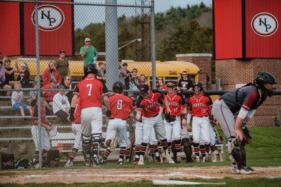 New Phila's Charlie Gibbs, 8, is congratulated after scoring from second on a double by Maddox Brown during the second inning against Dover Friday night.