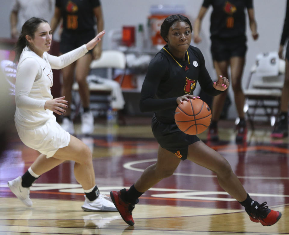 Louisville's Dana Evans, right, escapes Virginia Tech's Georgia Amoore after stealing the ball from her in the final moments of an NCAA college basketball game Thursday, Jan. 7, 2021, in Blacksburg, Va. (Matt Gentry/The Roanoke Times via AP, Pool)