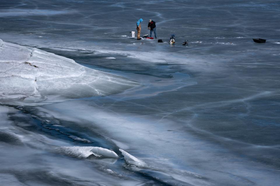 Ice fishermen check their lines on Fontenelle Reservoir, southeast of La Barge, Wyoming, on March 23, 2022. Wyoming is seeking to improve the dam so it can take more from it, but the resulting capacity would only be available if downstream states don’t require the water in the future.