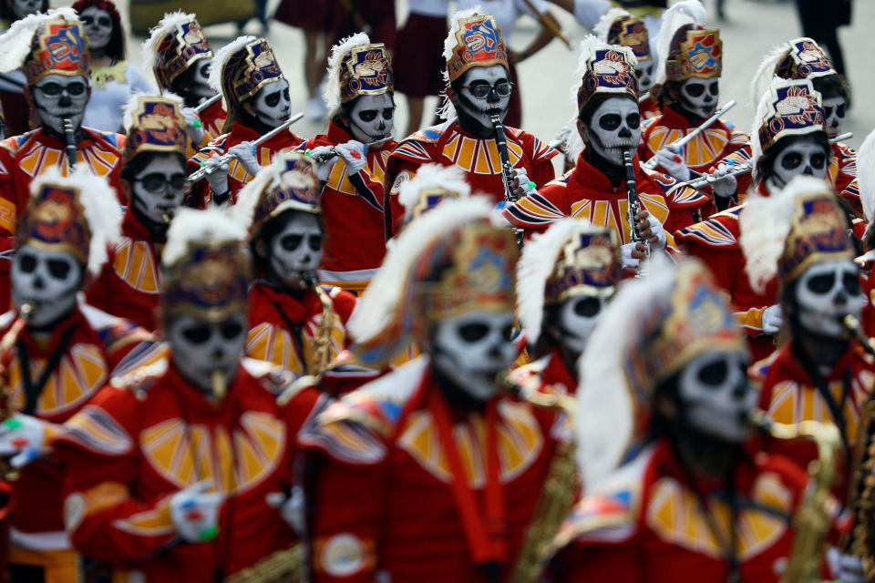 Masked musicians participate in a procession to commemorate Day of the Dead in Mexico City on Saturday.