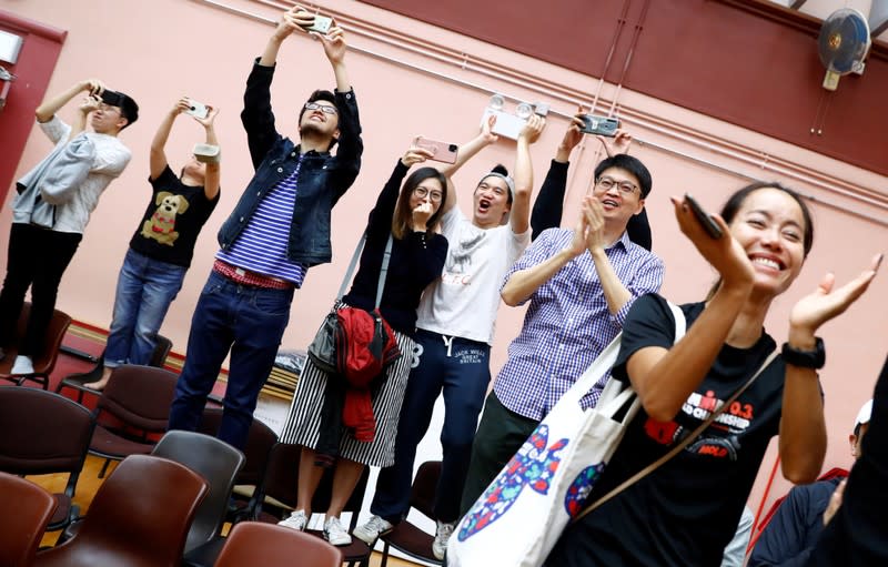 Supporters of local candidate Kelvin Lam celebrate at a polling station in the South Horizons West district in Hong Kong