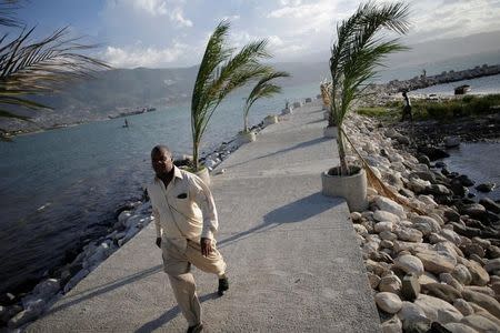 A man walks on a pier in Port-au-Prince, Haiti, October 1, 2016. REUTERS/Andres Martinez Casares