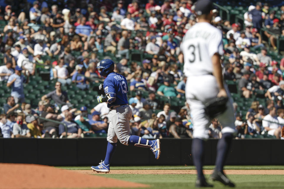 Kansas City Royals' Salvador Perez rounds third after hitting a two-run home run as Seattle Mariners starting pitcher Tyler Anderson looks on during the fifth inning of a baseball game Saturday, Aug. 28, 2021, in Seattle. (AP Photo/Jason Redmond)