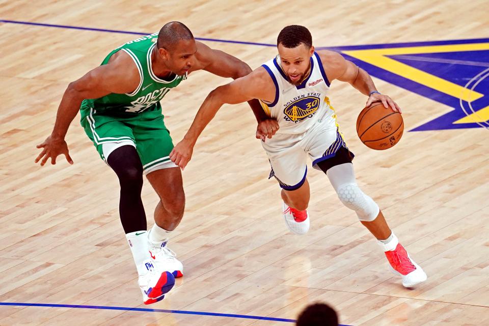 Golden State Warriors guard Stephen Curry (30) drives to the basket against Boston Celtics center Al Horford (42) during Game 2 of the NBA Finals.