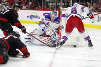 New York Rangers goaltender Igor Shesterkin (31) and teammate Jacob Trouba (8) control the puck in front of Carolina Hurricanes' Jesper Fast (71) and Nino Niederreiter (21) during the second period of Game 1 of an NHL hockey Stanley Cup second-round playoff series in Raleigh, N.C., Wednesday, May 18, 2022. (AP Photo/Karl B DeBlaker)