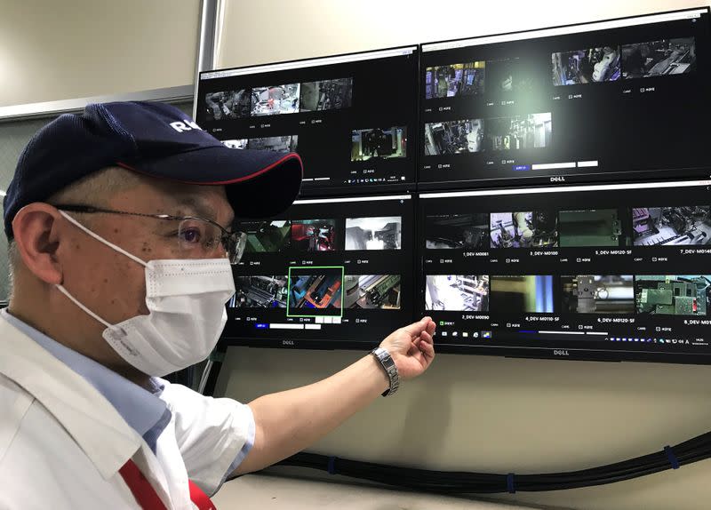 Ricoh Industry executive Kazuhiro Kanno explains the company’s system to remotely monitor production equipment at its printer components factory in Atsugi, Japan