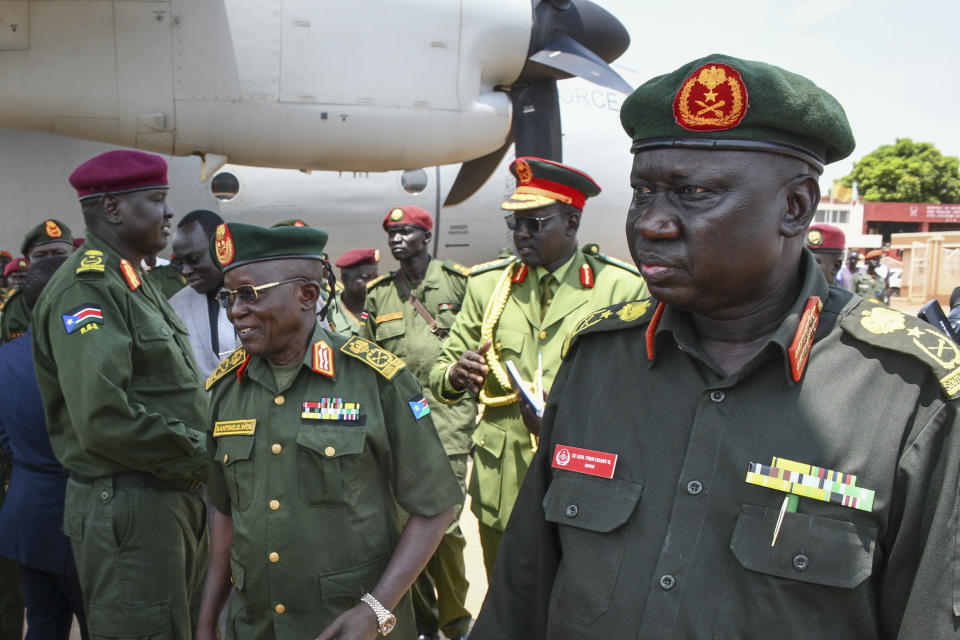 Deputy Chief of Defense Forces Lt. Gen. Thoi Chany Reat, right, attends a ceremony for soldiers from the South Sudan People's Defence Forces (SSPDF) preparing to join the East Africa Community Regional Force (EACRF) in Congo, at the airport in Juba, South Sudan Monday, April 3, 2023. A United Nations-backed panel of investigators alleges in a new report that several officials in South Sudan including Reat have perpetrated serious human rights violations and should be held accountable for their crimes. (AP Photo/Samir Bol)