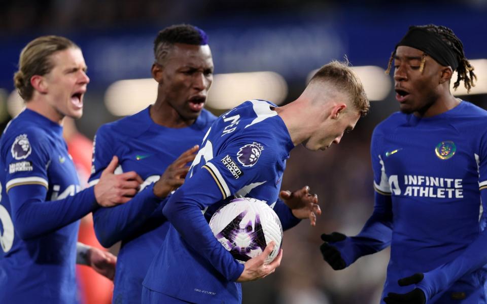 Cole Palmer (centre) takes the ball after Nicolas Jackson (second left) and Noni Madueke (right) also tried to grab it