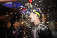 Philadelphia Phillies first baseman Rhys Hoskins is doused after a win over the Atlanta Braves in Game 4 of baseball's National League Division Series, Saturday, Oct. 15, 2022, in Philadelphia. The Philadelphia Phillies won, 8-3. (AP Photo/Matt Slocum)