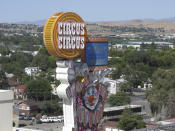 This photo taken Aug. 19, 2019 shows the famous clown at the Circus Circus casinos famous clown in front one of its downtown Reno, Nev., casino hotel where about 1,300 University of Nevada students are living this year after a gas explosion in July shut down two major dorms. The non-gambling, non-smoking building leased to the university for $21.7 million has been converted into Wolf Pack Hall exclusively for students through the 2019-2020 school year. (AP Photo/Scott Sonner)