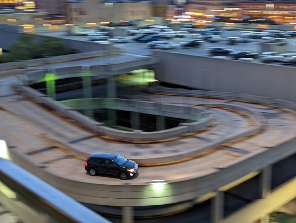 <p>Pixel 6 camera Motion mode Action Pan sample showing a car in focus while the parking lot ramp in the background is blurred.</p>
