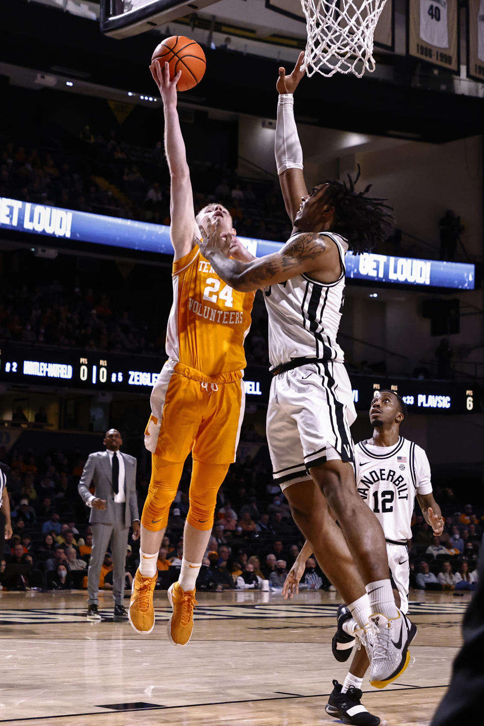 Tennessee guard Justin Powell (24) shoots over Vanderbilt guard Jamaine Mann (23) during an NCAA college basketball game Tuesday, Jan. 18, 2022, in Nashville, Tenn. (AP Photo/Wade Payne)