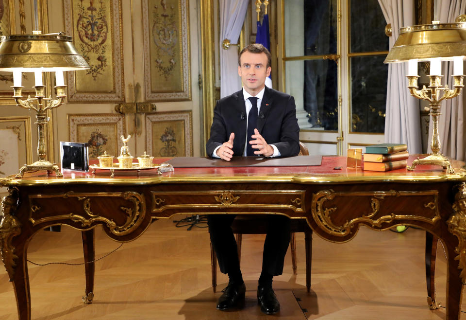 French President Emmanuel Macron poses before a special address to the nation, his first public comments after four weeks of nationwide 'yellow vest' protests, at the Elysee Palace, in Paris, Monday, Dec. 10, 2018. Facing exceptional protests, French President Emmanuel Macron is promising to speed up tax relief for struggling workers and to scrap a tax hike for retirees. (Ludovic Marin/Pool Photo via AP)