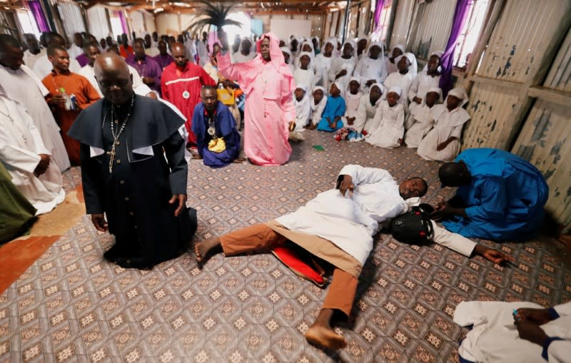 A faithful intercedes in prayers during a mass amid concerns about the spread of coronavirus disease (COVID-19) at the St. Joanes, Legio Maria African Mission Church within Fort Jesus in Kibera slums of Nairobi