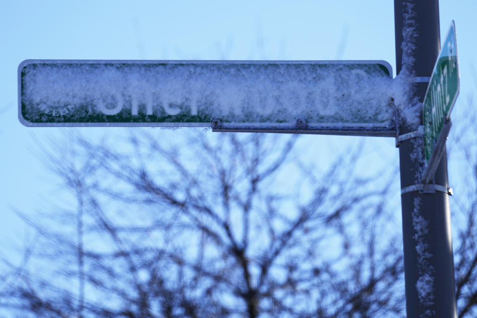 Road signs are covered by snow in Prospect Heights, Ill., Sunday, Jan. 14, 2024. Wind chill warning is in effect as dangerous cold conditions continue in the Chicago area. (AP Photo/Nam Y. Huh)