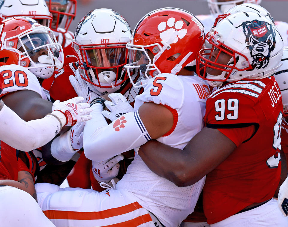 North Carolina State&#39;s Daniel Joseph tackles Clemson&#39;s D.J. Uiagalelei during the first half on Saturday. (Grant Halverson/Getty Images)