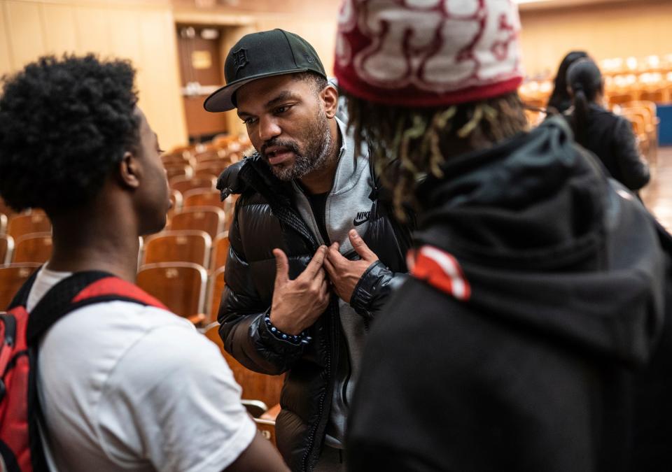 Deonte Morris, center, of Detroit, a member of the 4s, speaks with Pershing High School students Brian Jones, left, and Anthony Reese, right, about staying away from the gang life he is involved in after rival gang members from the 4s and 5s united to preach peace and an end to violence during an assembly at Pershing High School on Thursday, Feb. 1, 2023, in the aftermath of the killing of 11-year-old Latrelle Mines that occurred in early January 2024. Members of Ceasefire, Black Family Development and Detroit Friends and Family also spoke during the historic first time the rival gangs have been under the same roof promoting peace.