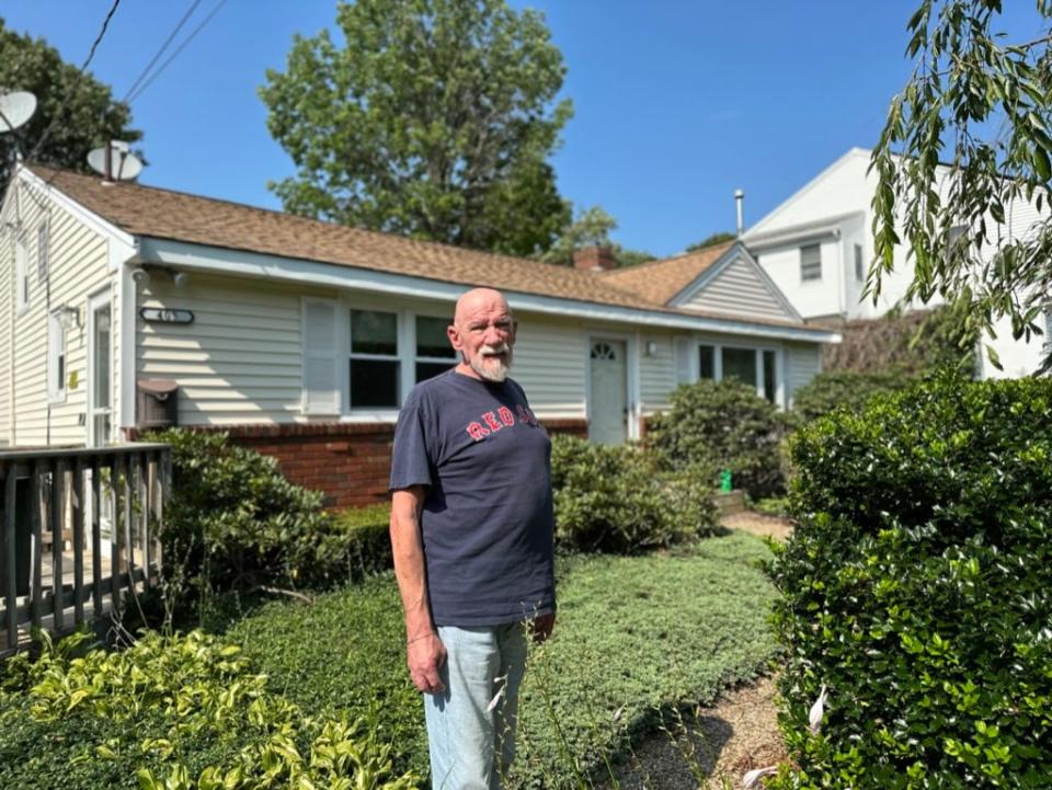 Allen Morris, 78, stands outside his home on Prospect Street, one house over from the intersection where at least 13 car accidents occurred since March 2022, according to crash records from Brockton Police Department.
