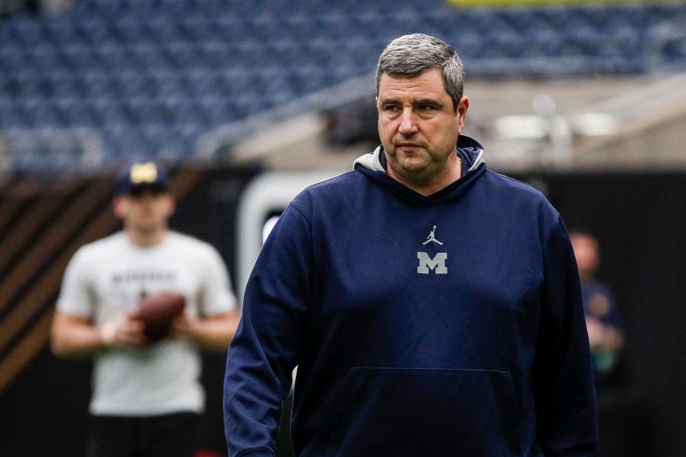 Michigan defensive line coach Mike Elston watches warm up during open practice at NRG Stadium in Houston, Texas on Saturday, Jan. 6, 2024.