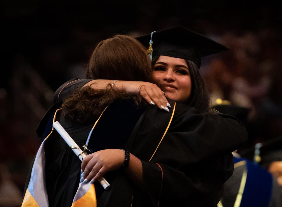 Deniss Moreno embraces a faculty member after receiving her degree in Moody Center. Moreno plans to teach fourth grade at Peebles Elementary School in Killeen, her hometown.