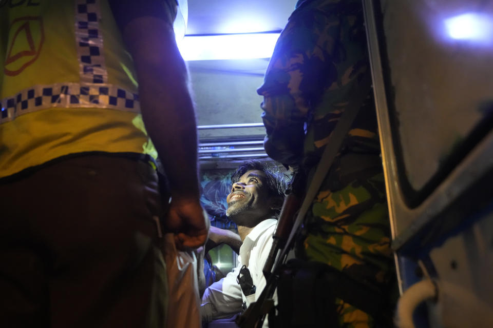 Sri Lankan police officers detain and question a suspected drug offender during a search operation against narcotics in Colombo, Sri Lanka, Thursday, Jan. 18, 2024. (AP Photo/Eranga Jayawardena)