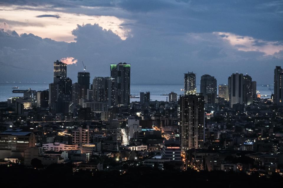 Buildings at dusk in the Central Business District (CBD) in Makati City, the Philippines, on Tuesday, Aug. 16, 2022. The Philippine central bank will sustain its rate-hike cycle this quarter, following a surprise move in July, to quell broadening price pressures, according to Bloomberg survey of economists. The benchmark interest rate is expected to increase by another 75 basis points to 4% by the end of September, a survey showed. Photographer: Veejay Villafranca/Bloomberg