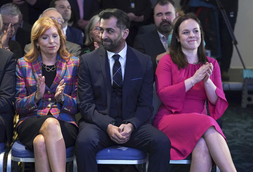 Scottish National Party leader candidates Ash Regan, left, and Kate Forbes applaud as Humza Yousaf, center, is announced new SNP leader, at Murrayfield Stadium, in Edinburgh, Scotland, Monday, March 27, 2023. Scotland’s governing Scottish National Party elected Yousaf as its new leader on Monday after a bruising five-week contest that exposed deep fractures within the pro-independence movement. The 37-year-old son of South Asian immigrants is set to become the first person of color to serve as Scotland’s first minister. (Andrew Milligan/PA via AP)