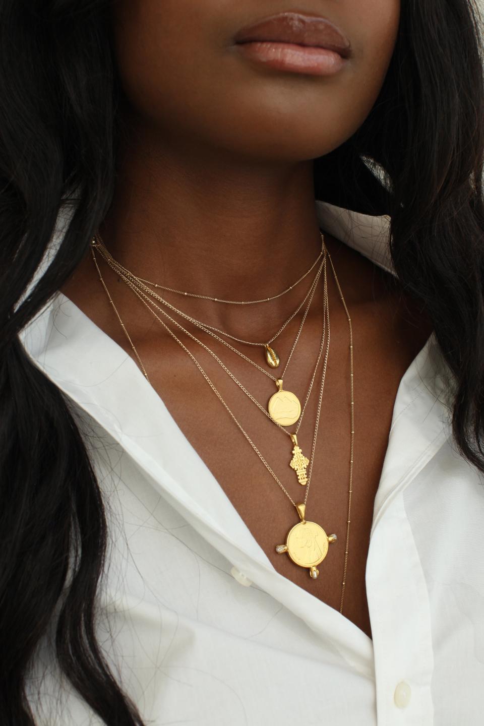 <p><a href="https://omiwoods.com/collections/necklaces/products/the-cowrie-abundance-necklace-i" rel="nofollow noopener" target="_blank" data-ylk="slk:Shop Now;elm:context_link;itc:0;sec:content-canvas" class="link ">Shop Now</a></p><p>Omi Woods THE COWRIE Abundance Necklace I</p><p>$89.00</p><p>omiwoods.com</p>