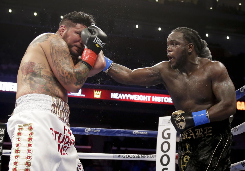 Bermane Stiverne, right, hits Chris Arreola during their rematch for the WBC heavyweight boxing title in Los Angeles, Saturday, May 10, 2014. Stiverne won the fight. (AP Photo/Chris Carlson)