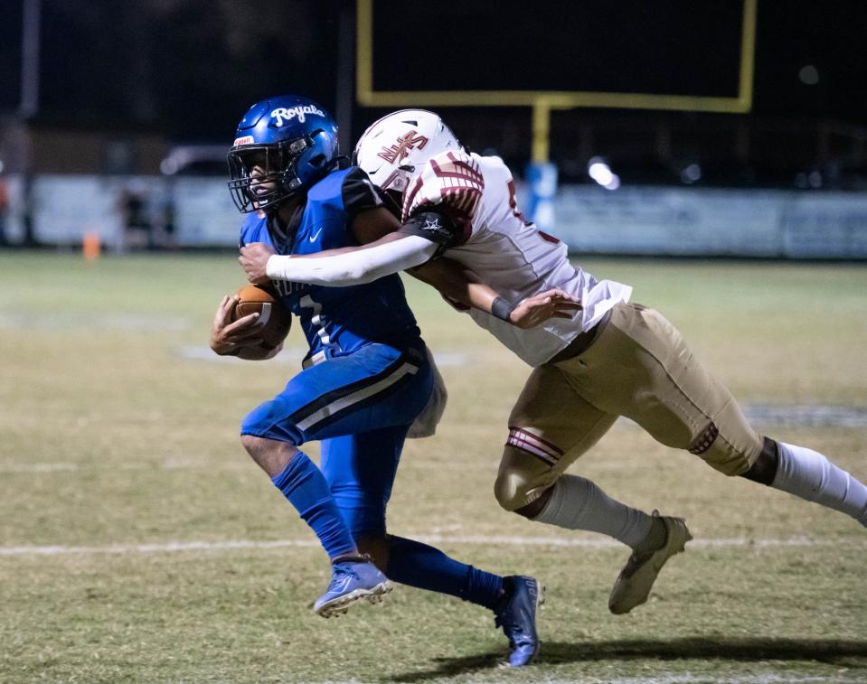 Quarterback Hayden Morris (1) is forced out of bounds by Joe Wright (50) during the Northview vs Jay football game at Jay High School in Jay on Friday, Oct. 14, 2022.