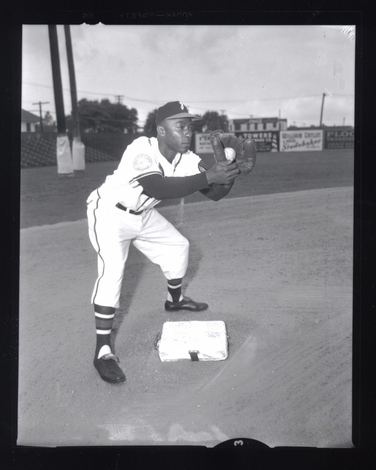 Henry Aaron straddles second base for a photo as a member of the Jacksonville Braves in 1953.