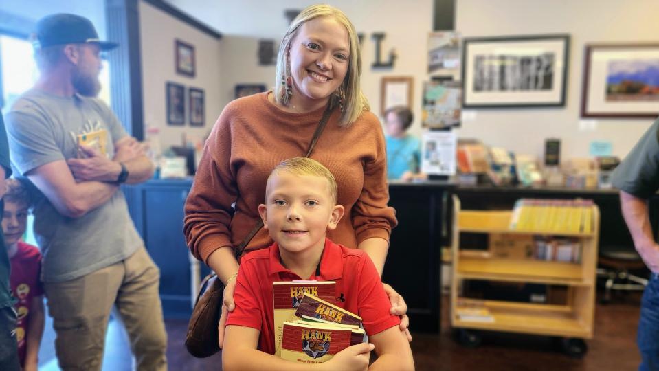 Aubrey Ball and her son Adler wait in line Thursday to meet John Erickson, author of "Hank the Cowdog," at the Burrowing Owl Books store in Amarillo.