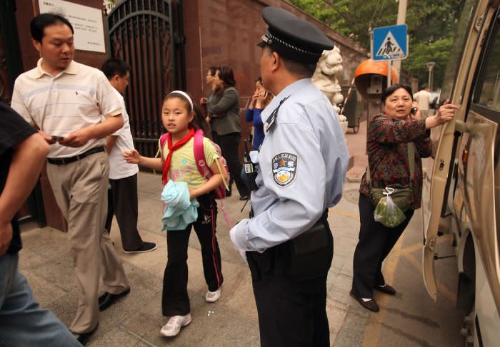 Extra security watches over students leaving school in Beijing on May 14, 2010, two days after an armed man attacked a kindergarten classroom.  File Photo by Stephen Shaver/UPI