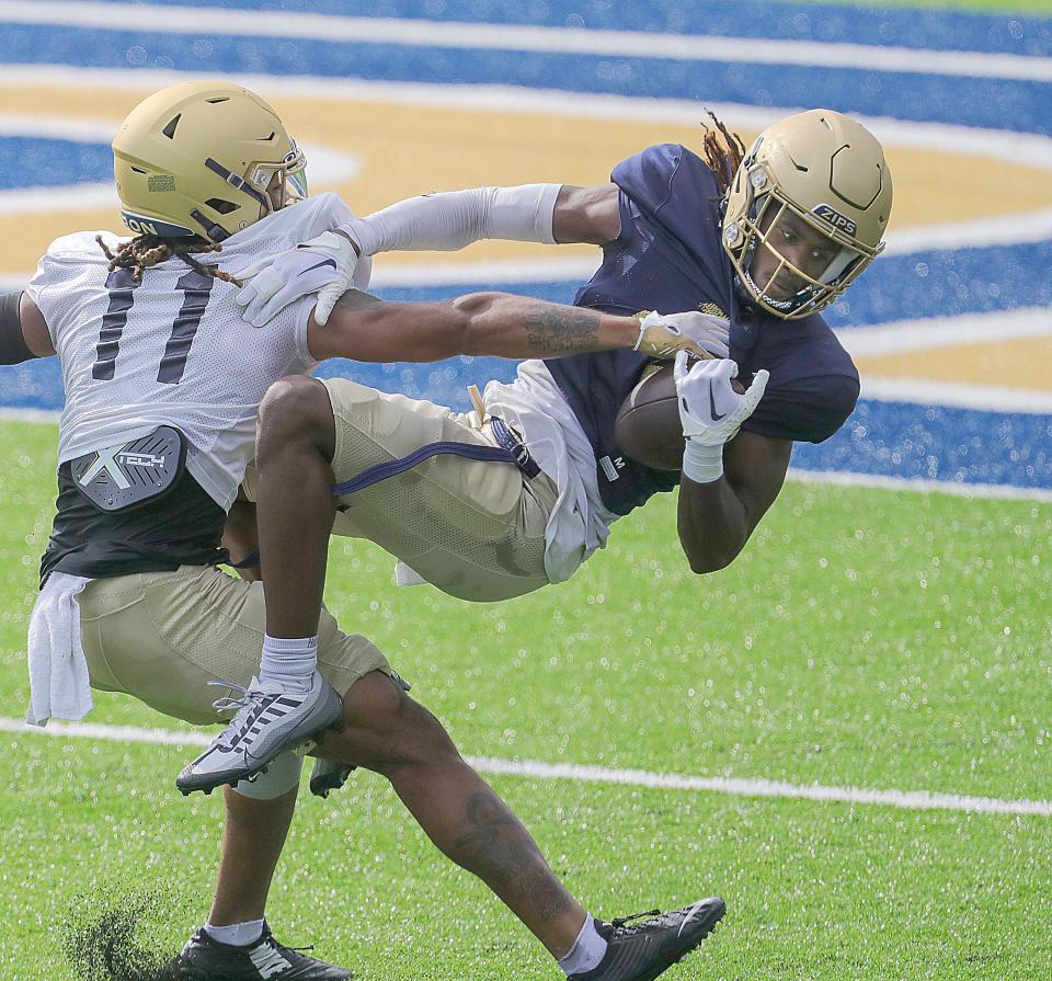 Akron's Jasaiah Gathings makes a catch in the red zone as Devonte Golden-Nelson defends during practice, Tuesday, Aug. 15, 2023.