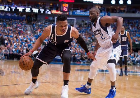 Dallas Mavericks guard Raymond Felton (2) guards Oklahoma City Thunder guard Russell Westbrook (0) during the second half in game three of the first round of the NBA Playoffs at American Airlines Center. The Thunder defeated the Mavericks 131-102. Mandatory Credit: Jerome Miron-USA TODAY Sports