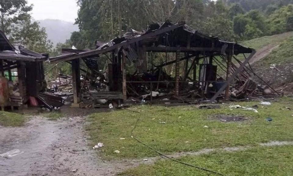 Debris scattered around destroyed wooden structures in Hpakant township, Kachin state, Myanmar in October 2022.