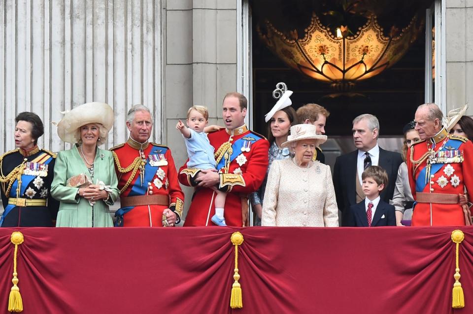 (L-R) Britain's Princess Anne, Princess Royal, Camilla, Duchess of Cornwall, Prince Charles, Prince of Wales, Prince William, Duke of Cambridge holding his son Prince George of Cambridge, Catherine, Duchess of Cambridge, Queen Elizabeth II, Prince Harry (back), Prince Andrew, Duke of York (back), James, Viscount Severn (front), Princess Beatrice of York (back), Prince Philip, Duke of Edinburgh and Princess Eugenie of York (back) stand on the balcony of Buckingham Palace waiting to view the fly-past during the Queen's Birthday Parade, 'Trooping the Colour,' in London, 2015 (AFP via Getty Images)