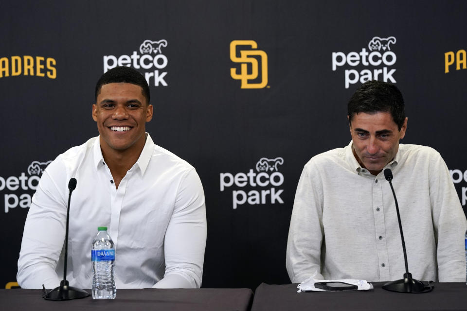 San Diego Padres outfielder Juan Soto, left, smiles as he sits alongside Padres president of baseball operations A.J. Preller, during a news conference at Petco Park Wednesday, Aug. 3, 2022, in San Diego. Soto, the generational superstar whose trade-deadline acquisition instantly made the Padres a strong playoff contender, was introduced at a news conference Wednesday along with fellow newcomer Josh Bell. (AP Photo/Gregory Bull)