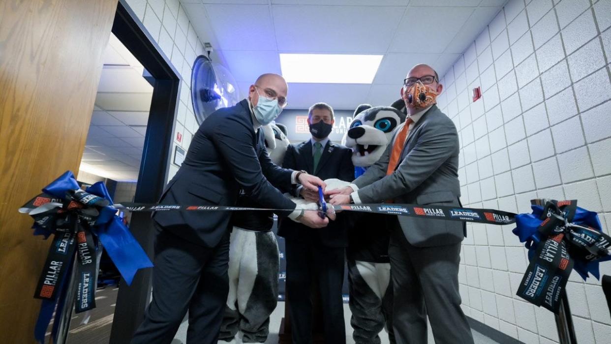Sam Moore (left), Dr. Ryan McCall (center) and Daniel Bradshaw (right), cut the ribbon on the MTC Esports Arena Dec. 2 along with the Marion Tech mascots.