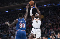 Denver Nuggets forward Paul Millsap (4) shoots a 3-pointer over New York Knicks forward Julius Randle (30) during the first half of an NBA basketball game Thursday, Dec. 5, 2019, at Madison Square Garden in New York. (AP Photo/Mary Altaffer)