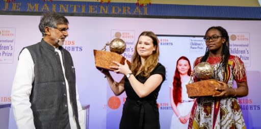 Nobel Peace Prize Laureate Kailash Satyarthi (L) presented the prizes to Luisa Neubauer (C - on behalf of Thunberg) and Divina Maloum (R)