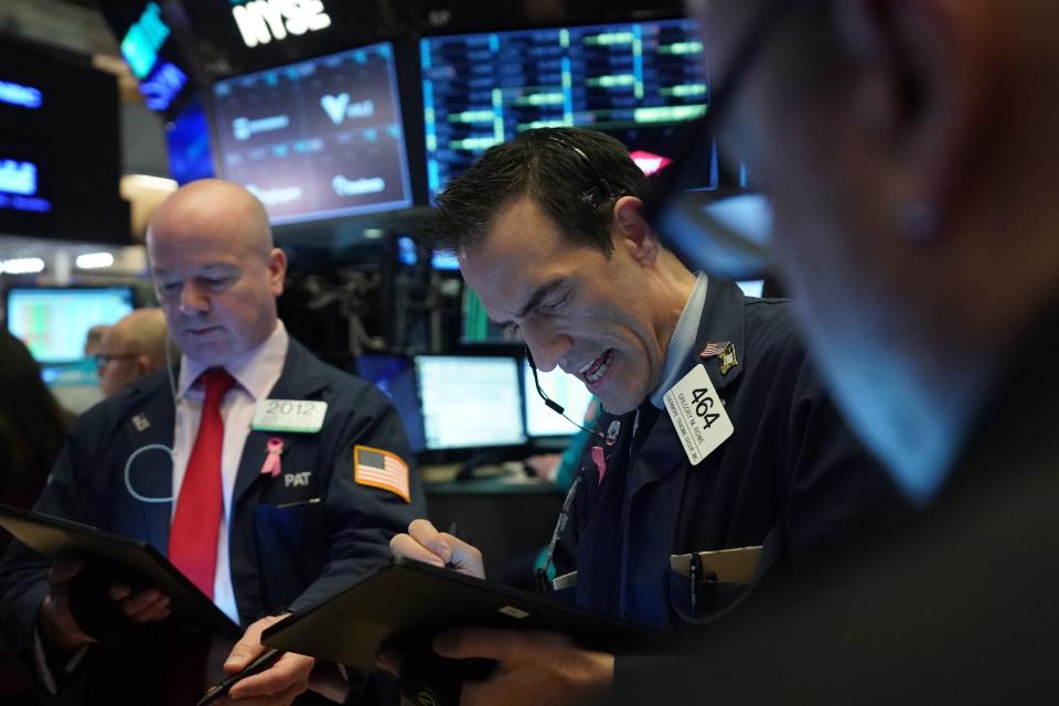 Traders work on the floor at the opening bell of the Dow Industrial Average at the New York Stock Exchange on March 12, 2020 in New York. - Wall Street stocks were deep in the red early Thursday, resuming after a 15-minute suspension as the economic pain from the coronavirus deepens and widens. About 25 minutes into trading, the Dow Jones Industrial Average was at 21,505.07, down more than 2,000 points or 8.7 percent. (Photo by Bryan R. Smith / AFP) (Photo by BRYAN R. SMITH/AFP via Getty Images)