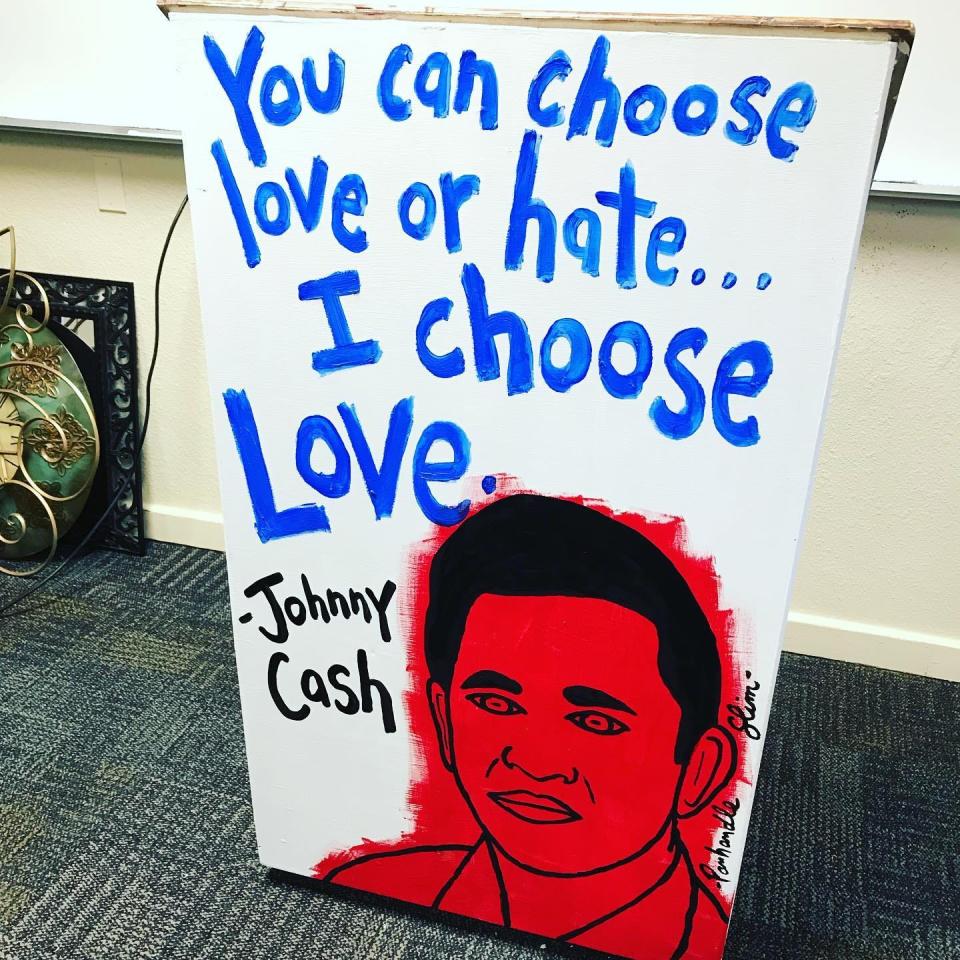 A Scott "Panhandle Slim" Stanton painting of Johnny Cash on a podium in a Milton High School classroom.