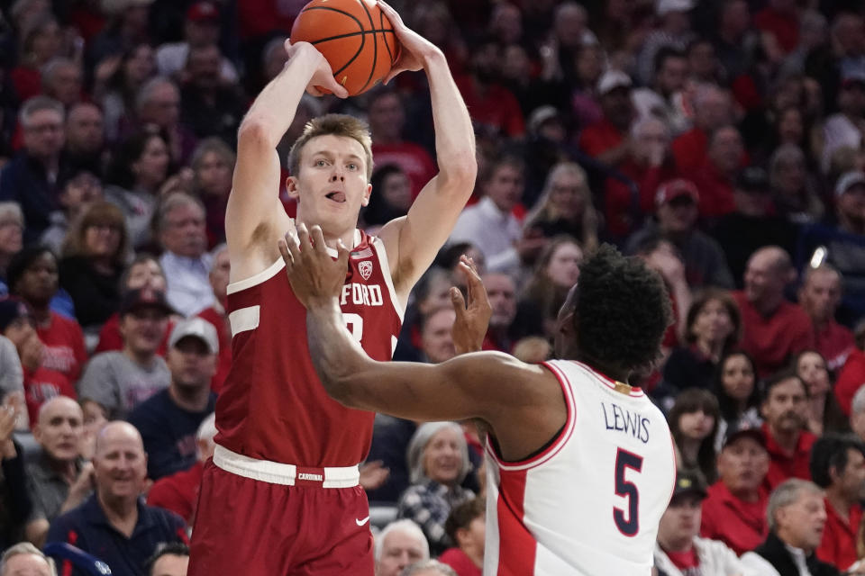 Stanford's Michael Jones, left, shoots over Arizona's KJ Lewis (5) during the first half of an NCAA college basketball game Sunday, Feb. 4, 2024, in Tucson, Ariz. (AP Photo/Darryl Webb)