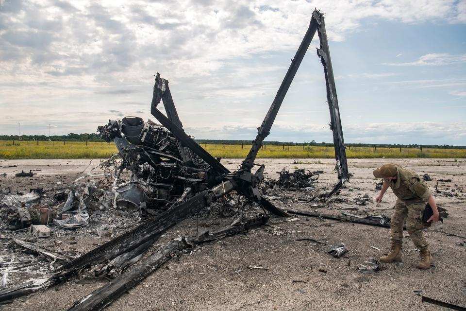 Ukrainian serviceman looks at Fragments of the Russian Military Ka-52 &quot;Alligator&quot; Helicopter Destroyed by Ukrainian Army during Russia's invasion of Ukraine at the Gostomel airfield near Kyiv, Ukraine. July 08, 2022