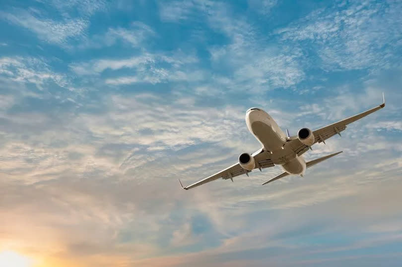 Airplane flying over tropical sea at sunset - Antalya, Turkey